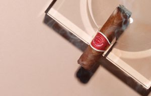 A cigar smokes in an ashtray